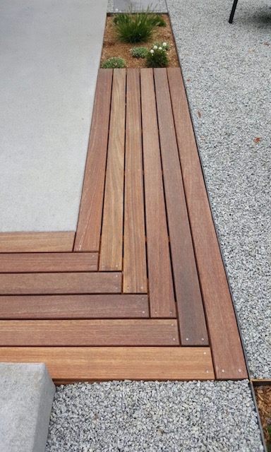 Timber decking meeting a stone edge